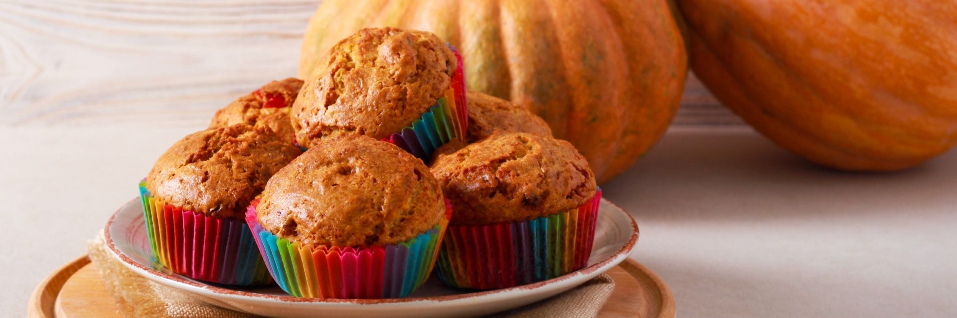 a plate of stacked Pumpkin-Oat Mini Muffins