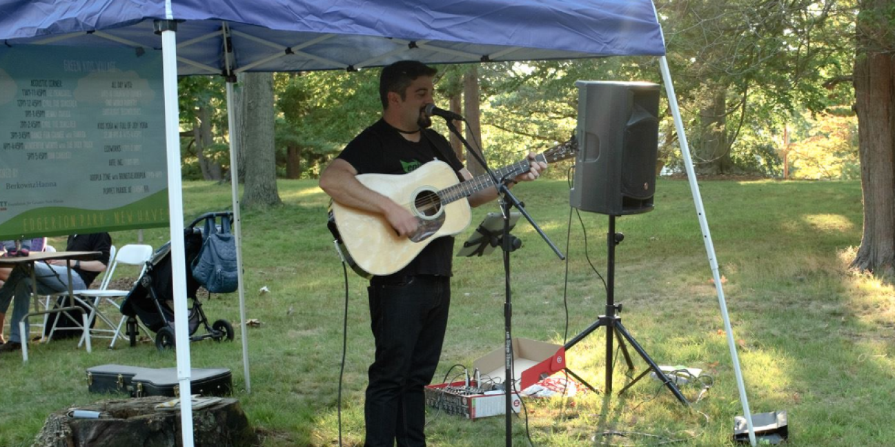 Dan Carlucci playing the guitar in the park