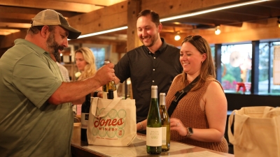 Guest with wine bottles at register