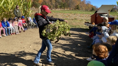 educator showing a pumpkin vine