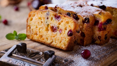 sliced Pumpkin Cranberry Tea Bread on a cutting board