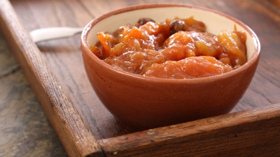 a bowl on a serving tray of Squash and Apricot Chutney