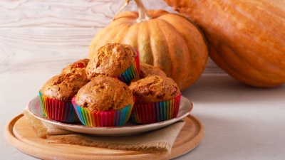 a plate of stacked Pumpkin-Oat Mini Muffins