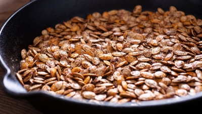 a skillet of Roasted Pumpkin Seeds