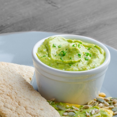 dip in small bowl on serving plate with pita bread